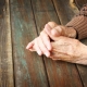 Older hands on a wooden table