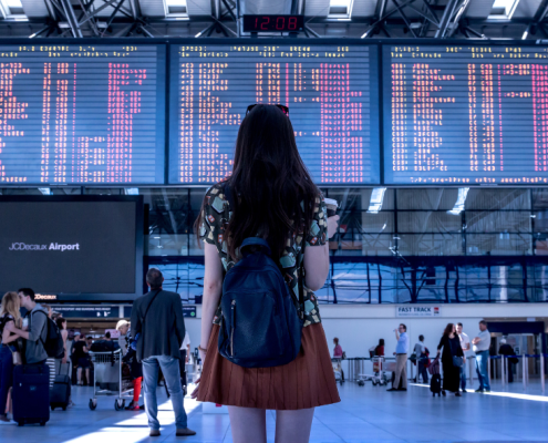 A woman staring at boards in Airport