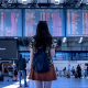 A woman staring at boards in Airport