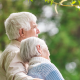 An older man with his arm around his wife