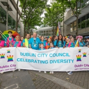 A group of people holding a large sign.