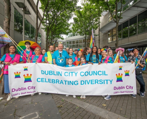 A group of people holding a large sign.