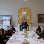 Government Minister talking to a room of people graduating